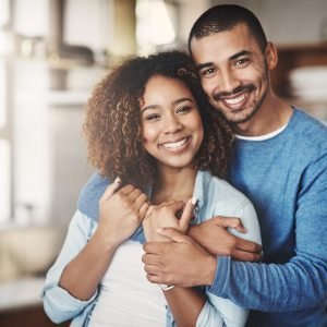 Portrait of a happy young couple in their kitchen at home